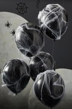 black and white balloons with spider web on them