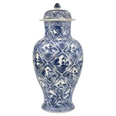 a blue and white vase with an ornate design on the lid is shown against a white background