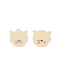 two wooden cat earrings with faces cut out of it's back and one in the middle