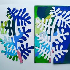 two pieces of paper with blue and green designs on them, one is cut out to look like leaves