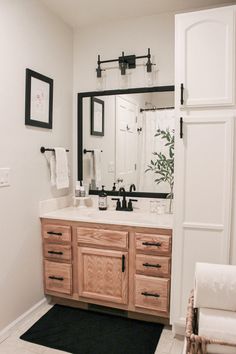 a bathroom with a sink, mirror and towel rack