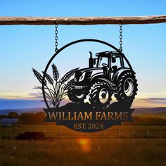 a farm sign hanging from the side of a wooden fence in front of a field