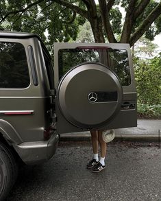 a person standing next to a vehicle with its door open