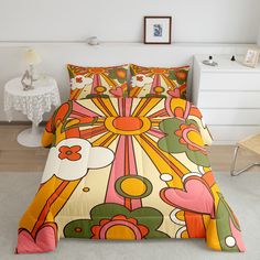 a bed covered in a colorful comforter next to a night stand