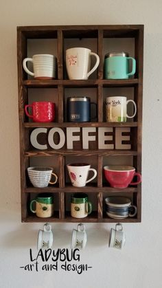 a wooden shelf with coffee cups and mugs on it's sides, hanging from the wall