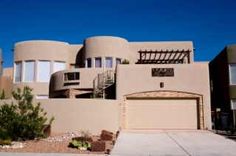 a large house with two garages in front of it