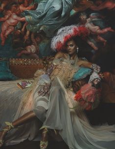 a woman sitting on top of a bed next to a painting