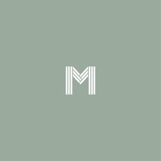 the letter m is made up of two white lines on a light green background,