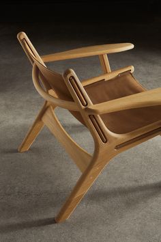 a wooden chair sitting on top of a cement floor