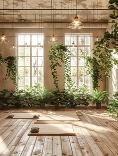 an indoor yoga studio with wooden flooring and potted plants on the windowsill