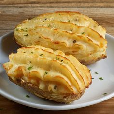 two pieces of baked potatoes on a white plate