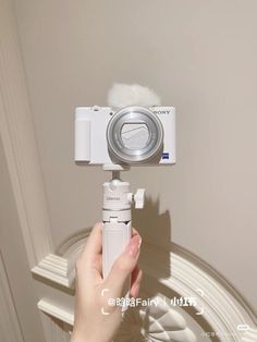 a person holding a camera up to the ceiling