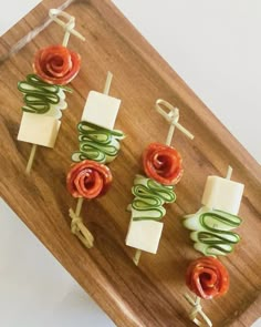 small appetizers are arranged on a wooden platter