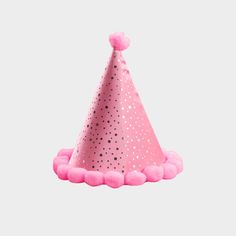 a pink party hat with polka dots on it