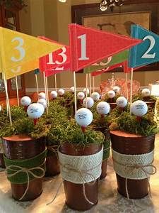 several pots with golf balls tied to them and flags in the top, on a table