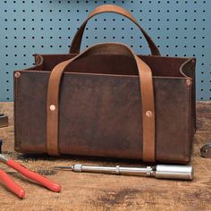 a tool bag sitting on top of a wooden table