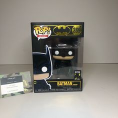 the batman pop vinyl figure is in its box next to it's package card