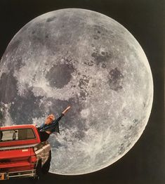 a man standing on top of a red truck in front of the moon