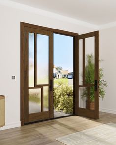 an empty room with two doors open and a potted plant in the corner next to it