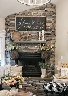 a living room filled with furniture and a fire place in front of a stone fireplace