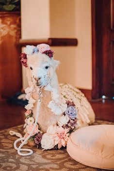 a white stuffed animal sitting on top of a bed