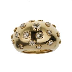 The Christian Dior Vintage Bombe Diamond 18k Yellow Gold Cocktail Ring is an exquisite piece that exemplifies the elegance and luxury synonymous with the Dior brand. This stunning cocktail ring is a perfect blend of classic design and sophisticated glamour, making it a must-have for any jewelry connoisseur. Crafted from 18k yellow gold, this ring features a bold and distinctive bombe design. The bombe style, characterized by its rounded, dome-like shape, creates a striking silhouette that is both eye-catching and timeless. The warm, rich hue of the yellow gold adds a touch of opulence, enhancing the overall allure of the piece. The surface of the ring is adorned with numerous bezel-set diamonds, each meticulously chosen for its brilliance and clarity. These diamonds are strategically place Luxury Dome Ring With 17 Jewels, Elegant White Gold Dome Ring With Brilliant Cut, Luxury White Gold Dome Ring For Formal Occasions, Luxury Formal White Gold Dome Ring, Luxury White Gold Dome Ring For Anniversary, Elegant White Gold Dome Ring With Single Cut Diamonds, Luxury Gold Diamond Evening Ring, Elegant Diamond Dome Ring With Polished Finish, Elegant Dome Ring With Pave Setting For Formal Occasions