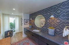 a bathroom with two sinks and a large mirror on the wall next to a window