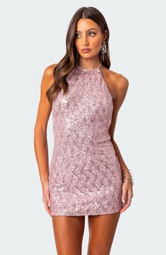 This party-perfect mini is designed in a sleek halter silhouette and covered with glittery allover sequins. Ties at neck Halter neck 95% polyester, 5% spandex Hand wash, dry flat Imported