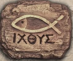 a stone with an image of a fish and the word yoxi written on it