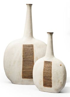 two white vases with brown lines on them