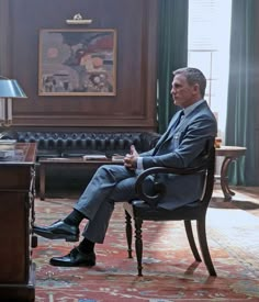 a man sitting in a chair next to a desk