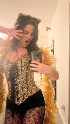 a woman in leopard print corset taking a selfie