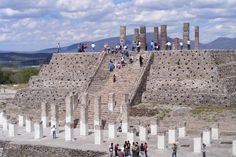 people are standing on top of an ancient structure