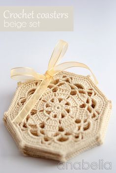 a crochet coaster with a ribbon tied around it