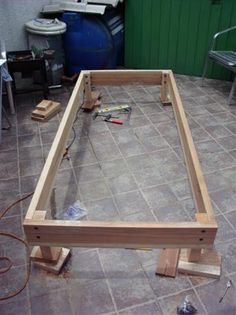 a wooden frame sitting on top of a tile floor