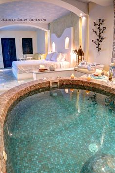 an indoor swimming pool surrounded by candles