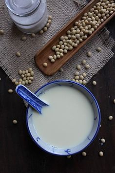 a bowl of milk and some chickpeas on a table