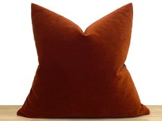 a brown pillow sitting on top of a wooden table