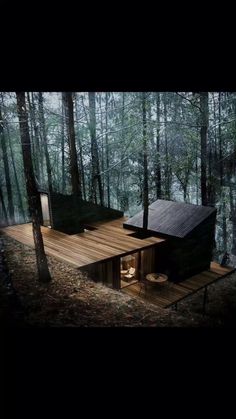 a small cabin in the middle of a forest with stairs leading up to it's roof