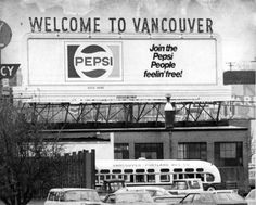 an old black and white photo of cars parked in front of a pepsi advertisement