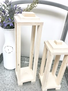 two white vases sitting next to each other on a table