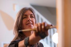 a woman holding a stick in her right hand