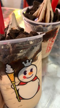 two plastic cups filled with ice cream and dirt