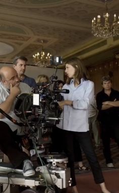 a group of people standing around a camera