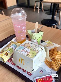 a tray that has some food on it and a drink in a cup next to it