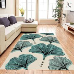 a living room filled with furniture and a large rug on top of a hard wood floor