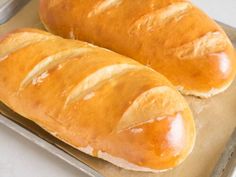 two loaves of bread sitting on top of a pan