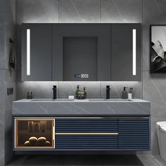 a modern bathroom with two sinks and a large mirror above the sink is illuminated by lights