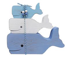 a wooden whale ornament hanging from a string