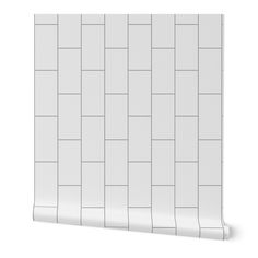 a white tile wallpaper with squares and lines on the bottom, in an angled position